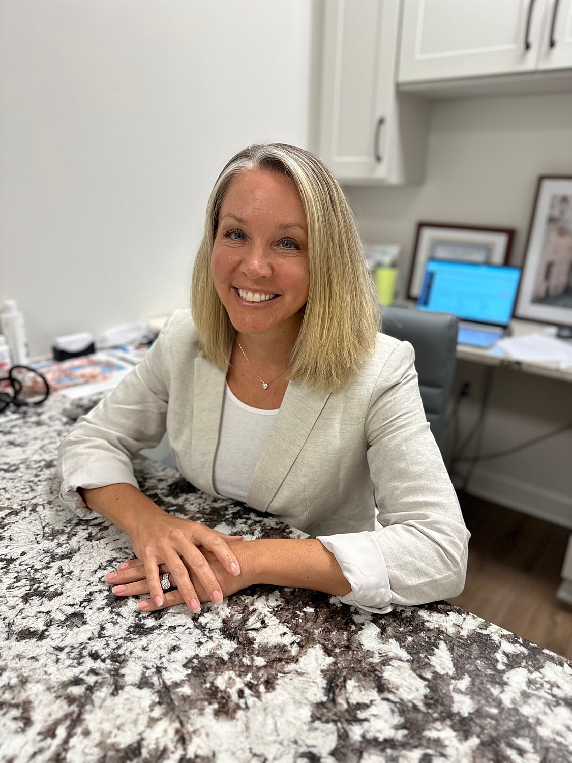 Smiling professional woman at a desk.