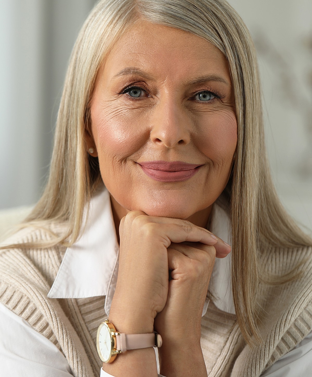 Smiling mature woman with elegant style and watch.