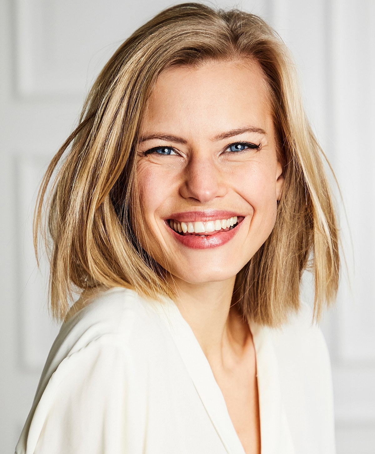 Smiling woman with blonde hair in bright setting