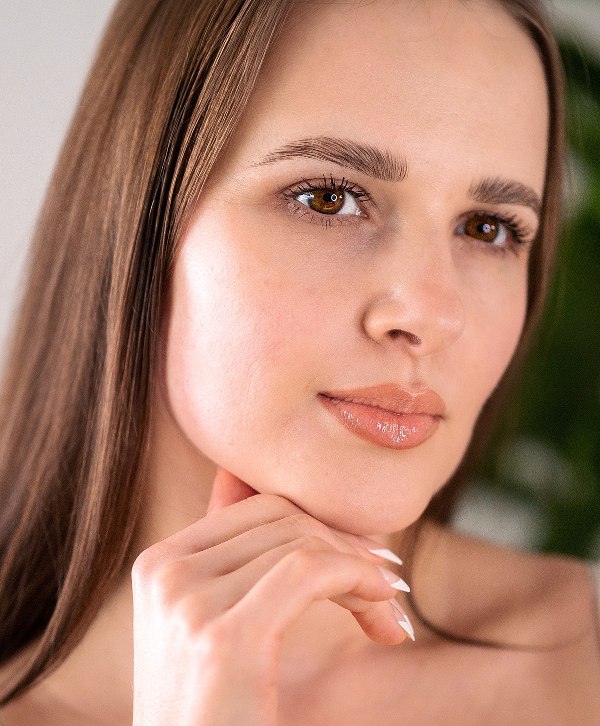 Young woman with long hair and thoughtful expression.