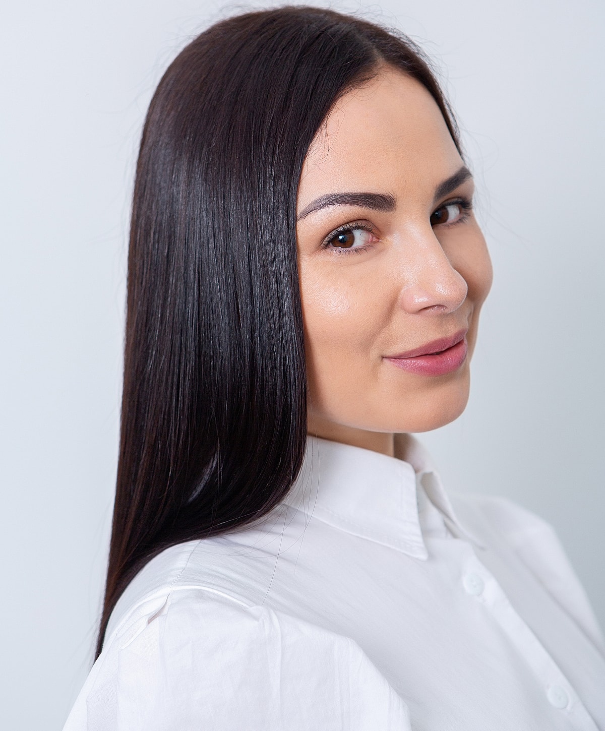 Woman with long hair in a white shirt.