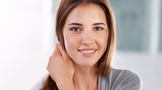 Smiling woman with long brown hair.