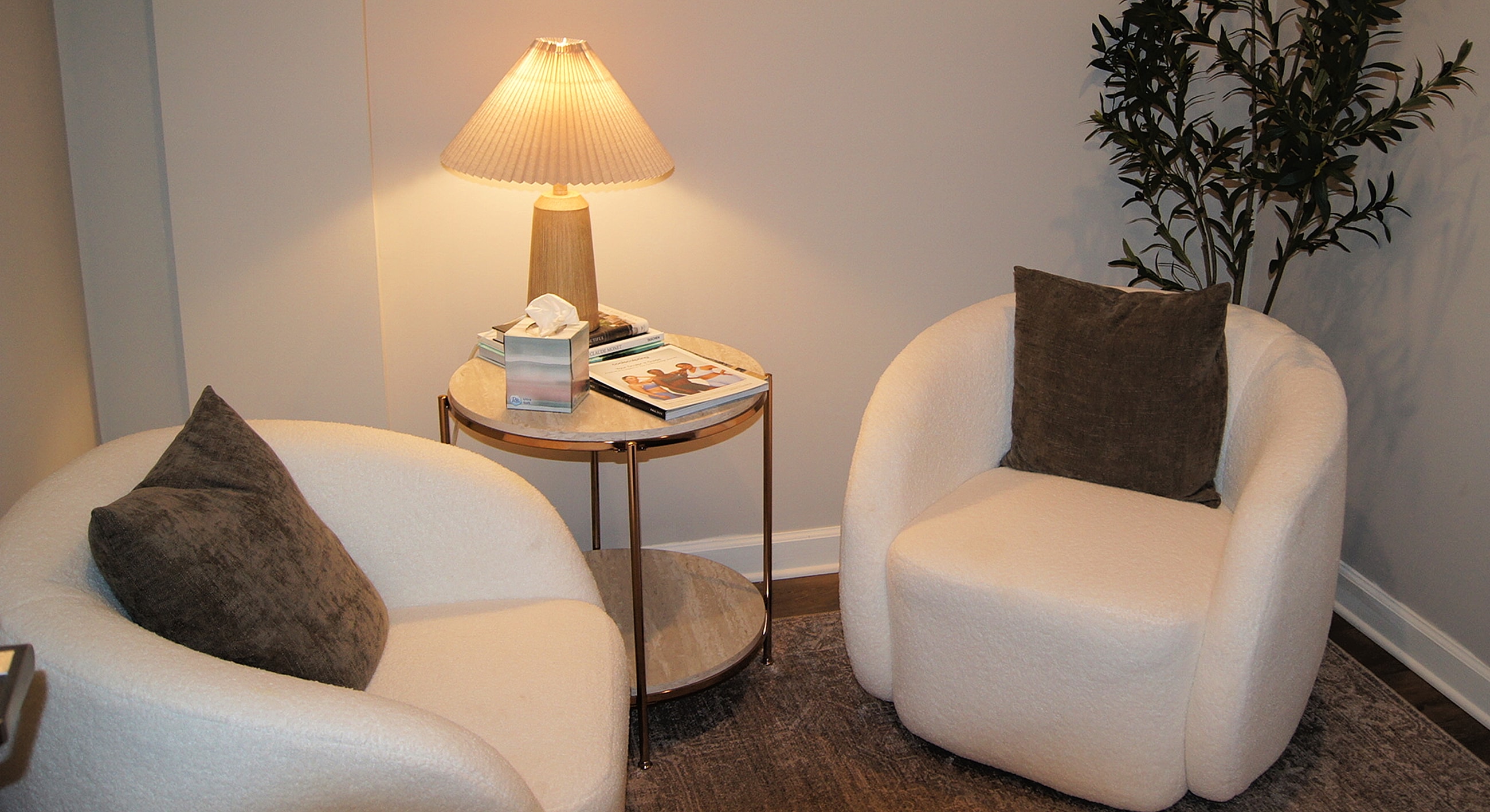 Cozy seating area with lamp and plants.