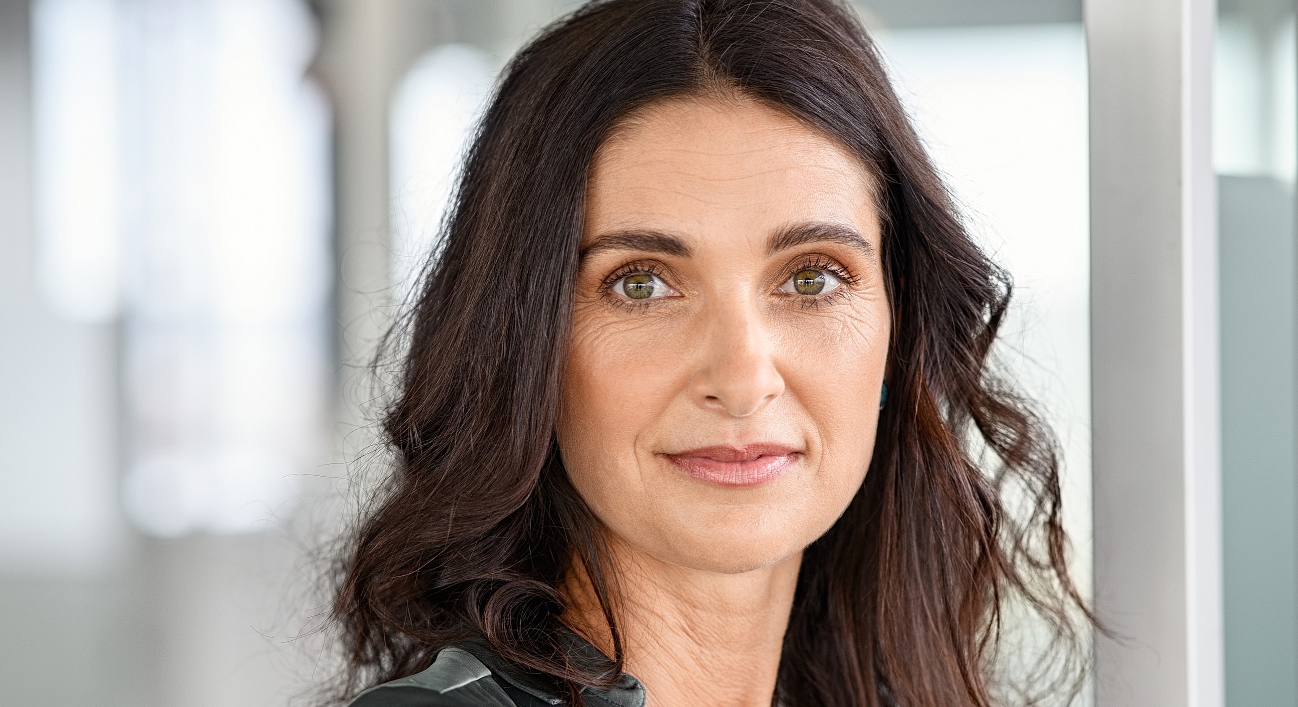 Portrait of a woman with dark hair.