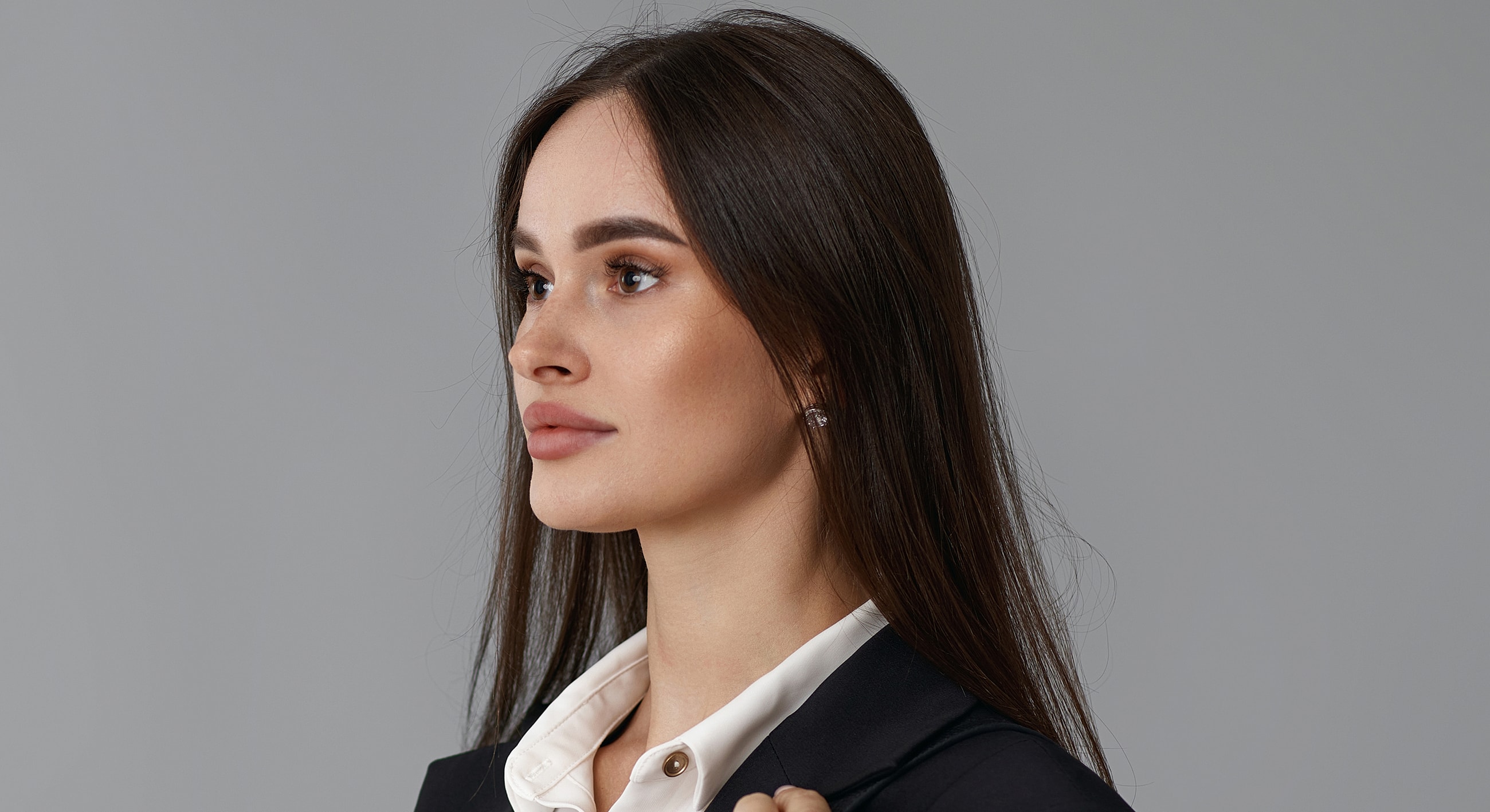 Professional woman with long hair in profile.