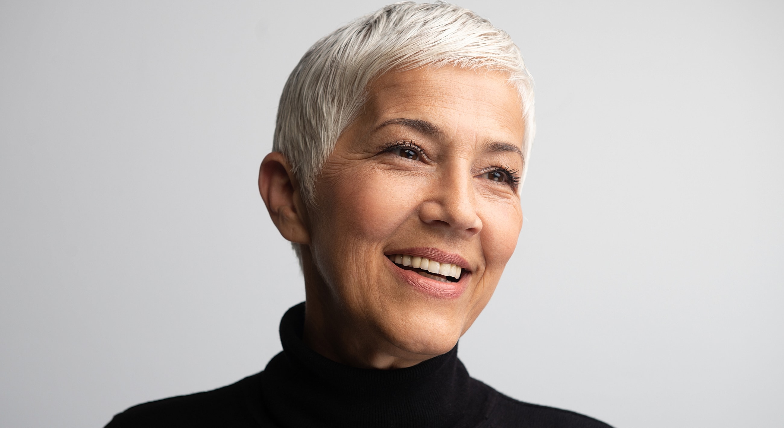 Smiling older woman with short gray hair.
